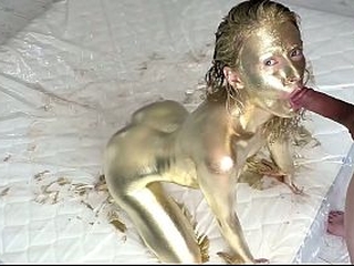 Pretty woman makes herself a golden body art, then gently fucks and sucks a dick, filled the whole body art with sperm